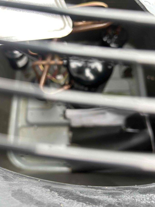 Conducted comprehensive electrical assessment for residential rewiring project at brick exterior property. Evaluated existing electrical infrastructure including exterior-mounted electrical boxes and outlets on brick wall near HVAC condensing unit. Inspected electrical connections and conduit routing for air conditioning system, examining both exterior junction boxes and internal electrical components within mechanical equipment housing. Documented current wiring configuration, insulated line sets, and electrical service connections to support rewiring estimate and scope of work development.