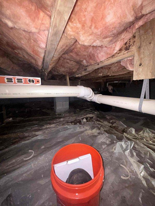 Completed sewer line restrap in crawl space beneath bathroom area. Two-person crew accessed underfloor space, repositioned and secured existing PVC sewer line with proper strapping and support to eliminate sagging and ensure adequate drainage slope. Work performed during requested 10-12 time window.