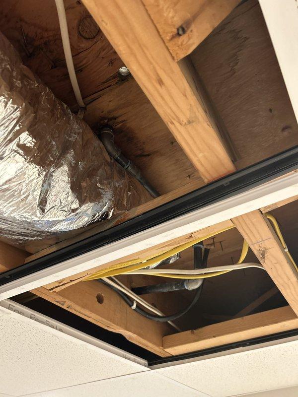 Relocated gas line for stove installation by rerouting the supply line into the wall cavity for a cleaner, code-compliant finish. Cut access opening in drywall to expose wall studs, installed flexible gas connector (CSST) through wall framing and secured routing through ceiling joists in attic space using proper support straps, then concealed piping within wall structure to eliminate exposed gas line from kitchen area.