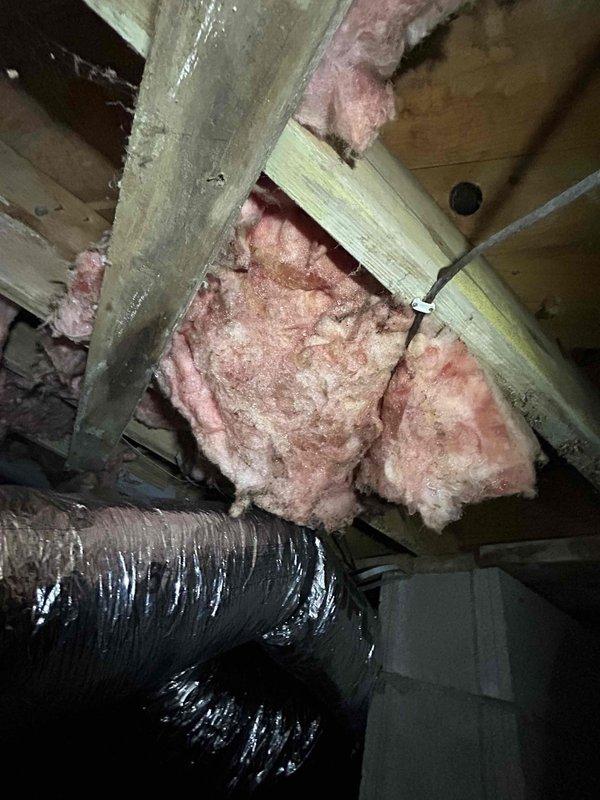 Responded to no cooling call on one-year-old electric HVAC system with flashing thermostat alert. Accessed indoor unit located in crawlspace to perform diagnostic inspection. Evaluated system components including flexible ductwork, refrigerant lines, electrical connections, and air handler assembly. Documented system configuration and current operating conditions through visual inspection of installation, including duct connections, insulation placement, and mechanical components mounted in crawlspace environment.