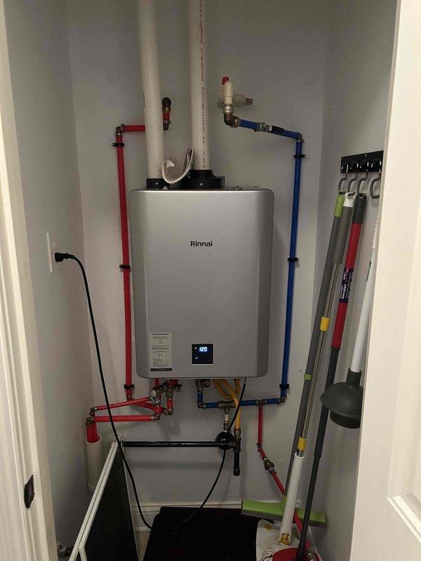 Performed routine maintenance flush on a 2-year-old Rinnai gas tankless water heater located in the utility room. Isolated the unit using the installed shut-off valves on the inlet and outlet PEX lines, connected flushing equipment, and circulated descaling solution through the heat exchanger to remove mineral buildup and sediment accumulation. Verified proper operation of the unit upon completion, confirmed temperature display functionality, and ensured all connections were secure with no leaks detected.