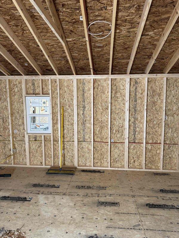 Completed comprehensive electrical rough-in and finish installation for commercial structure, including installation of 100-amp main service panel equipped with three single-pole breakers and one two-pole breaker. Installed complete wiring system throughout framed structure consisting of four GFCI receptacles, four duplex outlets, four single-pole switches, two keyless fixtures with bulbs, one ceiling fan with integrated lighting, two LED recessed can lights, and one LED dusk-to-dawn security flood fixture. Installed dedicated 240V 30-amp receptacle for HVAC equipment per code requirements. Work completed in two phases with initial rough-in inspection performed prior to return trip for trim-out and final device installation.