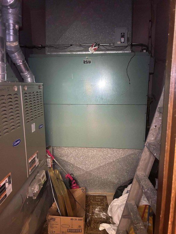 Responded to no cooling complaint in Sunday school area and annex where system was set to 68°F but reading 77°F with airflow present but not cool. Inspected Carrier furnace and air handler unit in mechanical room, verified thermostat operation showing 73°F setpoint with 75°F actual temperature, and documented equipment conditions. System evaluated for cooling capacity issues affecting temperature maintenance in occupied spaces.