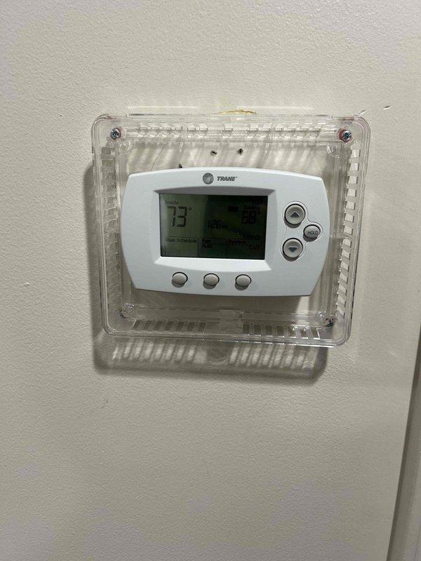 Responded to no cooling complaint in Sunday school area and annex where system was set to 68°F but reading 77°F with airflow present but not cool. Inspected Carrier furnace and air handler unit in mechanical room, verified thermostat operation showing 73°F setpoint with 75°F actual temperature, and documented equipment conditions. System evaluated for cooling capacity issues affecting temperature maintenance in occupied spaces.