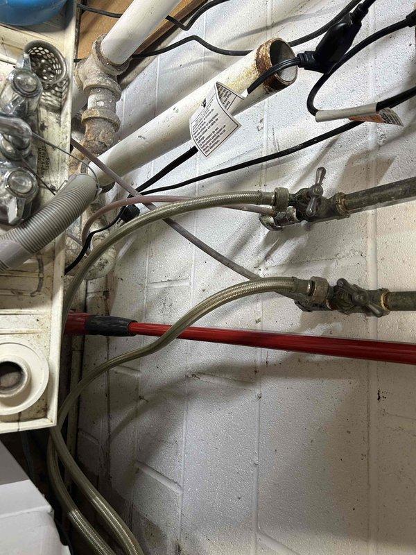 Installed new bucket pump to service existing washing machine and utility sink in basement area. Rerouted sump pump discharge line to exterior of building using white PVC piping with proper mounting brackets secured to concrete block walls. Verified all plumbing connections, tested pump functionality, and inspected system for leaks prior to completion. All components operational and watertight upon departure.