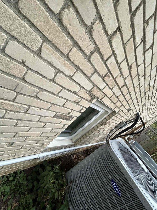 Installed approximately 40 feet of 1 1/4" black iron gas piping to supply a new standby generator. Routed piping along the lower exterior wall of the structure, securing it with appropriate pipe straps per code requirements. Applied white paint to the exposed gas line to match the existing building aesthetics. Installed yellow-handled gas shut-off valve for emergency isolation. All work completed in accordance with local gas fitting codes and manufacturer specifications for the generator installation.