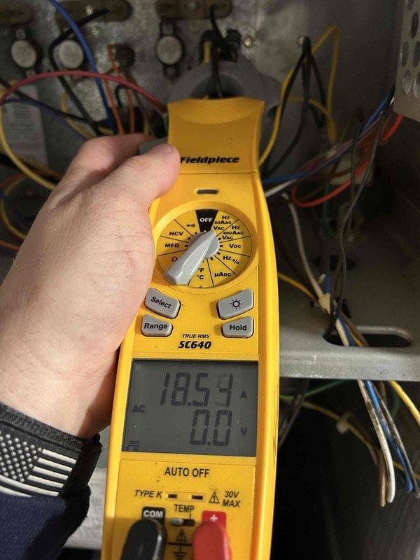 Completed comprehensive Care Plan tune-up on heat pump and air handler system located in basement. Performed electrical diagnostics using digital multimeter, measuring voltage and amperage at the outdoor unit's disconnect box and contactor assembly, confirming all readings within manufacturer specifications at 50.4V and 18.54V respectively. Inspected all electrical connections, wiring, and control components for proper operation and safety compliance.