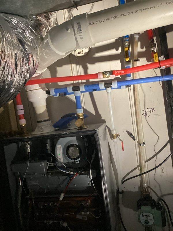 Responded to service call for two tankless water heaters experiencing intermittent shutdown issues and extended reboot times. Inspected both units, documented current installation with color-coded PEX supply lines and venting configuration. Assessed hot water delivery delay to kitchen sink and evaluated whole-home water pressure concerns for future remediation recommendations. Repaired leaking toilet on first floor by inspecting tank components, identifying deteriorated flush valve assembly with visible corrosion staining, and performing necessary repairs to restore proper operation and eliminate water loss.
