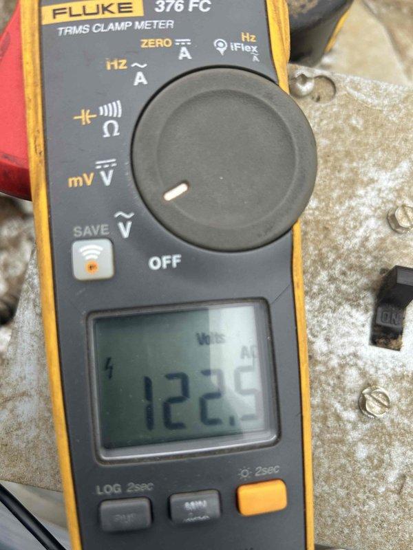 Responded to no cooling complaint on commercial HVAC system and performed comprehensive evaluation of all exhaust systems. Utilized Fluke 376 FC clamp meter to measure electrical parameters, recording 122.5 reading on system components. Inspected control board assembly within equipment panel, verifying proper connections on terminal blocks with yellow, red, and blue wiring, and confirmed all integrated circuits, capacitors, and multi-pin connectors were functioning correctly.