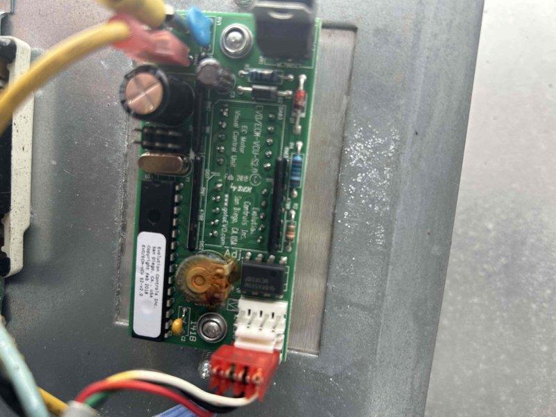 Responded to no cooling complaint on commercial HVAC system and performed comprehensive evaluation of all exhaust systems. Utilized Fluke 376 FC clamp meter to measure electrical parameters, recording 122.5 reading on system components. Inspected control board assembly within equipment panel, verifying proper connections on terminal blocks with yellow, red, and blue wiring, and confirmed all integrated circuits, capacitors, and multi-pin connectors were functioning correctly.