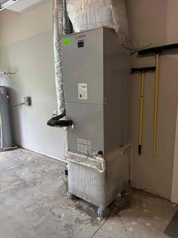 Responded to repeat water leak issue at Bosch air handler unit with standing water in filter box and active leaking. Inspected unit, ductwork connections, and condensate drainage system. Identified clogged condensate drain line causing water backup into filter compartment. Cleared obstruction from drain line, tested condensate pump operation, and verified proper drainage flow to prevent future water accumulation in unit.