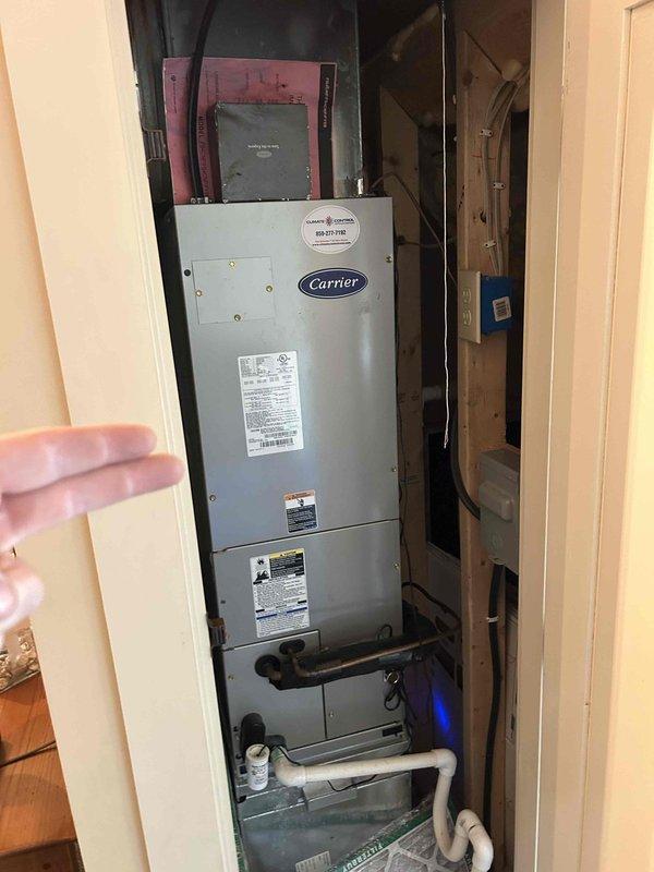 Completed comprehensive maintenance tune-up on HVAC system including air conditioning unit, gas furnace, heat pump, and air handler as part of care plan service. Performed visual inspection of furnace burner assembly, confirming proper ignition and flame characteristics across all burner ports, checked gas connections, and verified safe operation of heating components. Inspected Carrier air handler unit installation, examined condensate drain lines for proper flow, verified UV light system operation, and assessed overall equipment condition and accessibility within closet installation space.