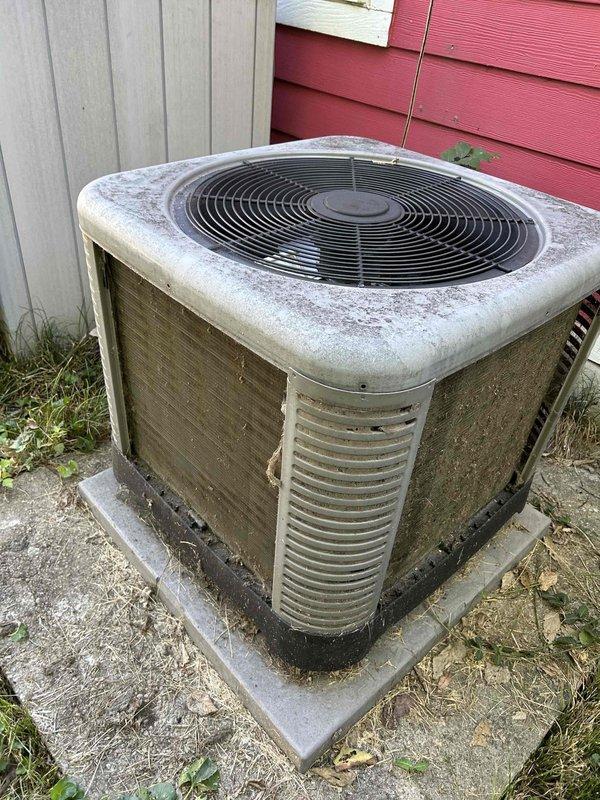Completed comprehensive Care Plan tune-up on heat pump and air handler system installed in 2021, accessing equipment in attic via ladder. Performed standard maintenance procedures on outdoor condenser unit, which showed significant weathering and dirt accumulation on housing, coils, and fan grille consistent with extended outdoor exposure. Documented equipment condition through photographs showing heavy soiling on condenser fins and exterior surfaces requiring attention during service visit.