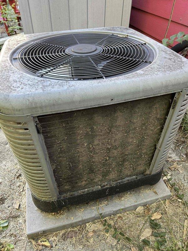 Completed comprehensive Care Plan tune-up on heat pump and air handler system installed in 2021, accessing equipment in attic via ladder. Performed standard maintenance procedures on outdoor condenser unit, which showed significant weathering and dirt accumulation on housing, coils, and fan grille consistent with extended outdoor exposure. Documented equipment condition through photographs showing heavy soiling on condenser fins and exterior surfaces requiring attention during service visit.