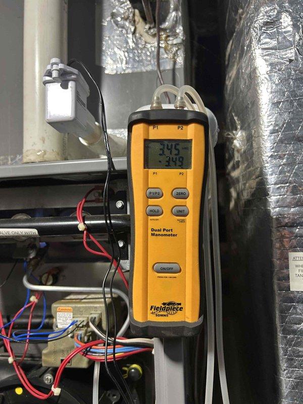 Completed comprehensive Care Plan tune-up on gas furnace and air conditioning system located in basement. Performed diagnostic testing using digital manometer to measure gas pressure readings (345-348 range) and multimeter to verify electrical system functionality (403 reading captured). Inspected all electrical connections, control board components, and wiring harness. Evaluated blower motor operation, tested capacitors, and verified proper voltage supply to unit. Checked ductwork integrity and system airflow. Customer supplied air filters as previously arranged. All system components operating within manufacturer specifications upon completion of maintenance service.