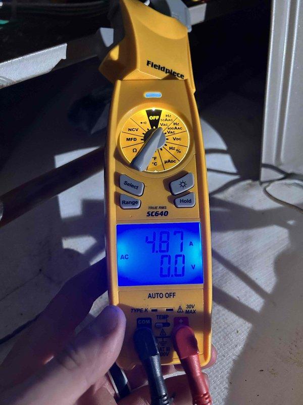 Performed routine HVAC maintenance on ground floor air conditioning equipment located in crawlspace. Conducted electrical diagnostics and measurements using clamp meter, recording amperage draw of 4.87A and voltage readings to verify proper system operation. Customer maintains their own 16x25x4 filter supply separately.