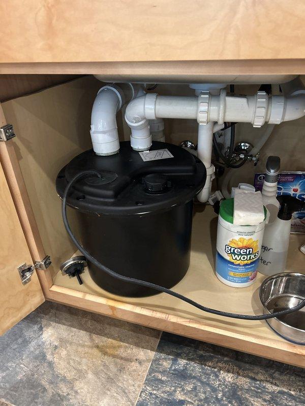 Responded to service call for basement sink and toilet backing up with drainage issues. Upon inspection, located and documented the main water shut-off valve system with copper piping configuration and verified proper operation of shut-off controls. Examined under-sink plumbing connections including PVC drain lines and garbage disposal unit to assess drainage system integrity and identify potential blockage points in the main drain line.