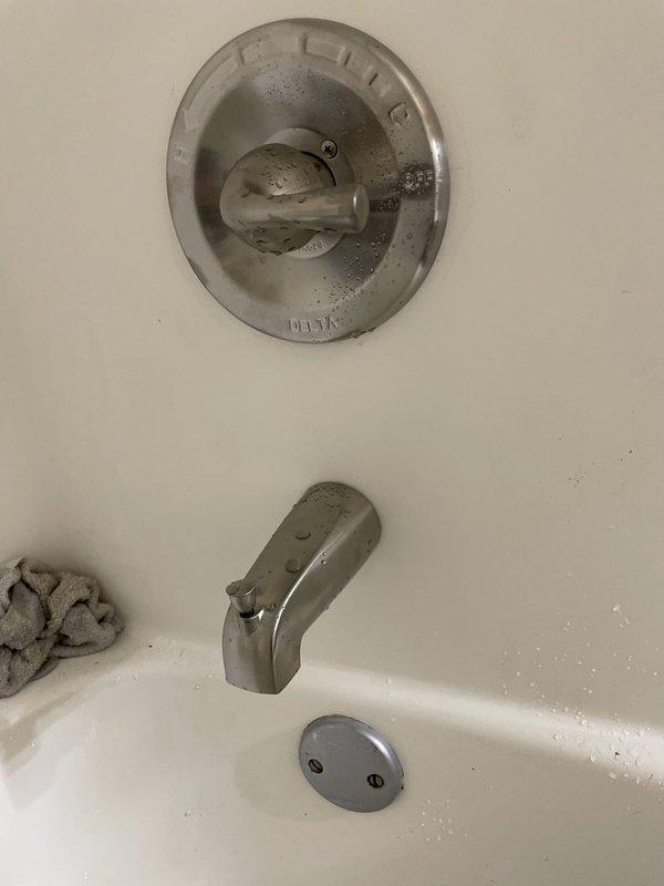 Responded to upstairs bathroom for Delta-branded tub/shower combo faucet with continuous water flow that would not shut off completely. Replaced defective shower valve assembly with customer-provided Delta fixture. Shut off water supply, removed old trim and cartridge, installed new valve components, tested operation to confirm proper shutoff and temperature control, and verified no leaks at connections.