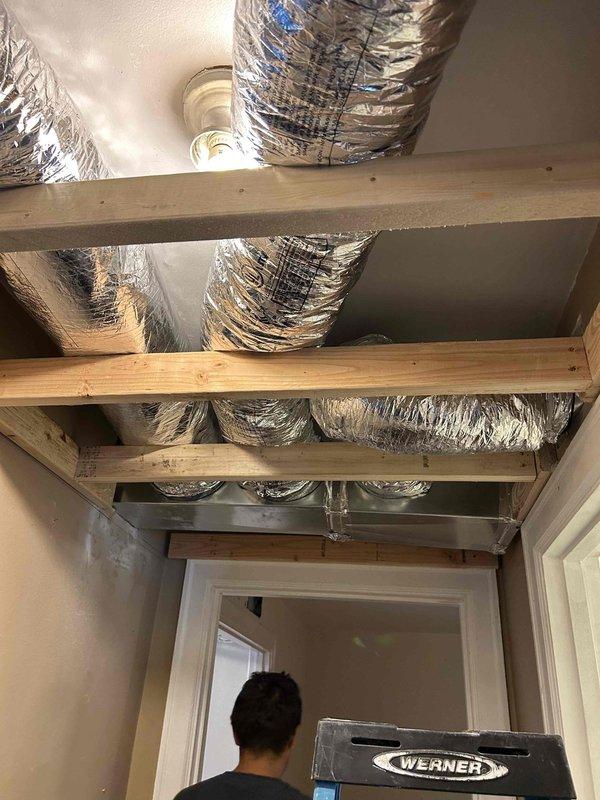 Completed full residential HVAC system installation consisting of six 2.5-ton Ruud heat pump systems with matching air handlers, 10KW auxiliary heat kits, and digital thermostats throughout the living space. Installed new ductwork system including insulated flexible ducts routed through attic and ceiling spaces, with proper framing and register openings prepared for final installation. System includes outdoor unit pads with snow legs, electrical disconnect boxes, whip kits, refrigerant line insulation and filtration, coil drain safety sensors, overflow drain pans with water sensors, transitions to existing ductwork, and standard air filter racks. All equipment removed and disposed of properly, with installation completed per code requirements and all applicable permits obtained.