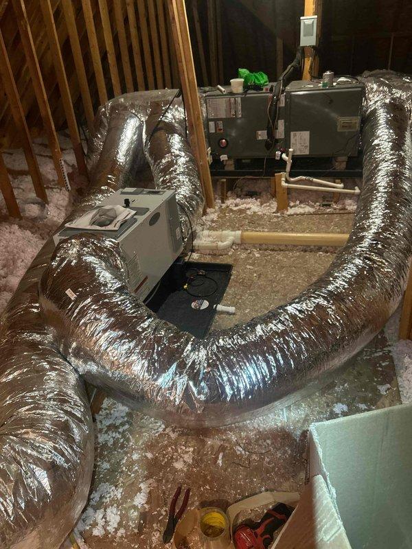 Installed two customer-supplied Honeywell Elite Pro 1200 thermostats and customer-supplied dehumidifiers in attic space. Added secondary drain pan beneath air handling unit, installed overflow safety float switch, and completed condensate drainage system with PVC piping to prevent water damage from potential equipment leaks.