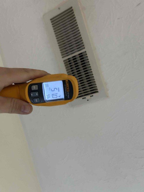 Completed comprehensive HVAC maintenance inspection on 20+ year old heat pump and air handler system located in interior closet. Performed temperature diagnostics at supply vent using infrared thermometer to verify proper air discharge temperatures. Accessed outdoor condensing unit and inspected electrical compartment, noting debris accumulation and insect activity on control board platform that was cleaned during service. Verified all electrical connections, capacitor condition, and contactor operation. Customer declined filter replacement service and will provide their own filters for installation.