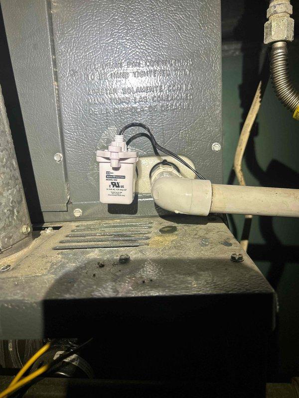 Installed condensate overflow safety switch on 14-year-old Goodman HVAC system to prevent water damage by automatically shutting down the unit when the drain pan backs up. Replaced failed 20 MFD brand-specific capacitor for the upstairs blower motor to restore proper system operation.