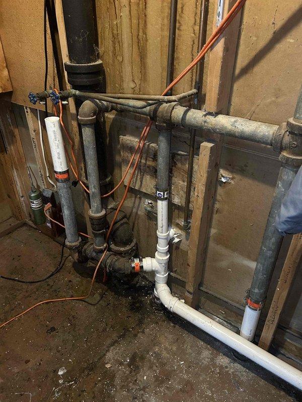 Completed kitchen drain reroute in basement mechanical area. Installed new PVC drainage piping to redirect kitchen waste line, integrating with existing plumbing infrastructure and ensuring proper pitch for drainage flow. All connections secured and tested for leaks.