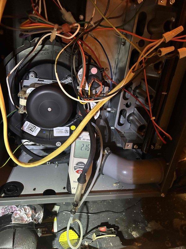 Completed comprehensive care plan tune-up on attic-mounted AC and gas furnace system accessed through garage. Performed diagnostic testing using digital clamp meter, measuring amperage draw at 2.16 amps on indoor blower motor and 0.60 amps at outdoor condensing unit. Inspected all electrical connections, including blower motor wiring harness with multiple wire terminations. Tested capacitor operation at outdoor unit. Verified proper system operation for both heating and cooling components. Customer provided 14x20x1 filters for installation as specified.