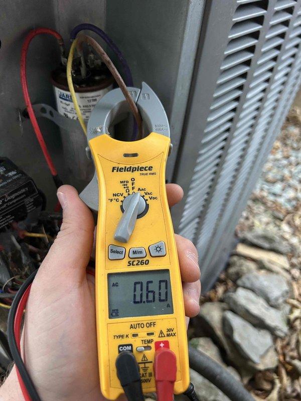 Completed comprehensive care plan tune-up on attic-mounted AC and gas furnace system accessed through garage. Performed diagnostic testing using digital clamp meter, measuring amperage draw at 2.16 amps on indoor blower motor and 0.60 amps at outdoor condensing unit. Inspected all electrical connections, including blower motor wiring harness with multiple wire terminations. Tested capacitor operation at outdoor unit. Verified proper system operation for both heating and cooling components. Customer provided 14x20x1 filters for installation as specified.
