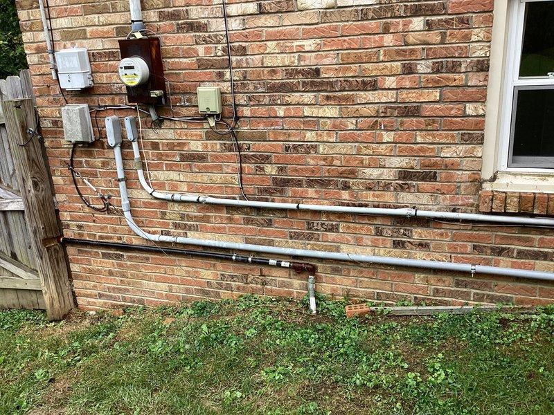 Conducted site evaluation for installation of customer-supplied 24KW residential standby generator unit. Assessed existing electrical service infrastructure including main meter location, available mounting space on exterior brick wall, and current utility connection configuration. Documented existing electrical panel access, conduit routing pathways, and determined optimal generator placement adjacent to existing meter and service equipment. Evaluated requirements for transfer switch installation, load center integration, and necessary electrical connections to accommodate automatic transfer system. Identified conduit paths for generator feed lines and verified adequate clearances per manufacturer specifications and local code requirements for generator installation on residential structure.