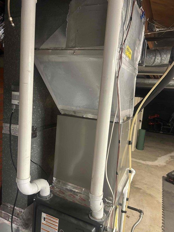 Successfully completed residential air conditioning and evaporator coil installation. Installed Bryant 3-ton up to 17 SEER2 outdoor condensing unit (model GA5SAN53602W) with new outdoor pad, electrical disconnect box, and electrical whip kit. Installed Bryant 3-ton evaporator coil (model CVAVA3617XMA) positioned on top of existing furnace. Fabricated and installed insulated supply transition from new coil to existing supply plenum using foil-backed insulation. Ran and insulated refrigerant lines with filter drier installation. Re-installed gas drip leg to code compliance. Integrated existing thermostat with new system. Installed SS2 coil drain safety water sensor and tested operation. Removed and disposed of old equipment. Verified all electrical connections, refrigerant charge, and system operation. System tested and operational upon completion.
