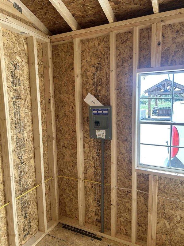 Completed full electrical installation for a 12x24 commercial structure, installing all outlets at 36-inch height per specifications. Installed and wired a 100-amp main electrical panel with two breakers, one GFCI receptacle, two duplex outlets, one single-pole switch, and one keyless light fixture with bulb. Ran metal conduit from the main panel and established proper grounding and circuit protection throughout the structure. All electrical work was completed in the rough-in phase within the exposed framing, with wiring routed through studs and appropriate junction boxes mounted to structural members. Installation passed required electrical inspection, and a return trip was made to complete final trim-out and finishing work after wall coverings were installed.