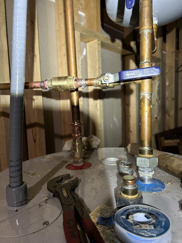 Responded to intermittent water leak in basement plumbing system. Upon inspection, identified leak source at copper pipe connections near water heater. Examined ball valves, brass fittings, and solder joints on vertical and horizontal copper supply lines. Tightened connections at T-fitting junctions and replaced compromised brass fittings where corrosion and age had degraded seals. Verified all shut-off valves were functioning properly and confirmed pipe insulation was intact. Tested system under pressure to ensure leak was resolved and all connections remained dry. System restored to normal operation with no further signs of water seepage.