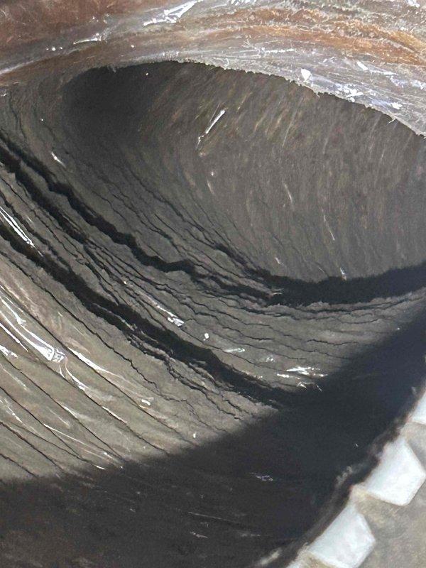 # HVAC Maintenance Service Completed

Performed comprehensive club membership maintenance on residential HVAC system with air conditioning, gas furnace, and humidifier located in crawlspace. Upon inspection, discovered severe frost and ice buildup completely covering the evaporator coil, indicating a critical system malfunction. The coil was obscured by thick crystalline frost accumulation across all visible surfaces, with moisture present in the drainage pan below.

Additionally, documented extensive contamination within the ductwork system. Interior duct surfaces showed heavy accumulations of dust, dirt, and particulate matter forming thick, matted layers that had built up over extended period without maintenance. The contamination was uniform throughout the visible duct interior, significantly compromising air quality and system efficiency.

Customer provided their own 20x20x1 filter and Trion G206 humidifier pad as specified for this maintenance visit. Completed standard club servi