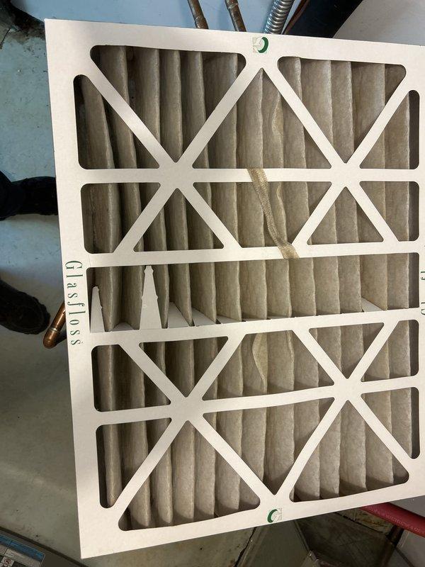 Completed routine maintenance tune-up on HVAC system located in garage closet. Performed comprehensive inspection of unit components, replaced 20x25x4 Glasfloss air filter, and documented equipment condition with photos of system labels and new filter installation.
