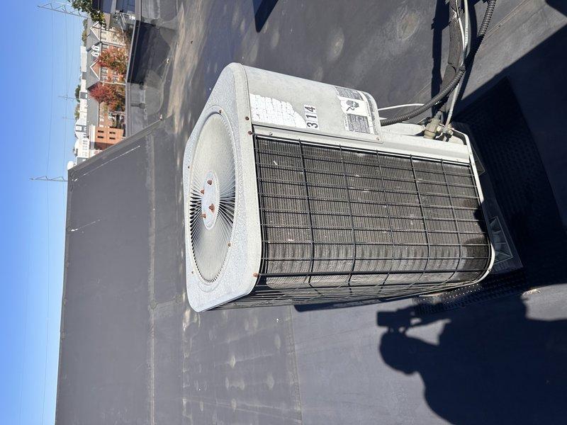 Completed full system replacement for apartment-style rooftop HVAC unit that was over 10 years old and experiencing complete cooling failure. The existing electric unit had fan operation but no cooling capacity for approximately three weeks, with indoor temperature at 73 degrees despite thermostat set to 68 degrees. Replaced entire system including rooftop condenser unit and indoor air handler located in utility closet, restoring full cooling functionality to the residential unit.