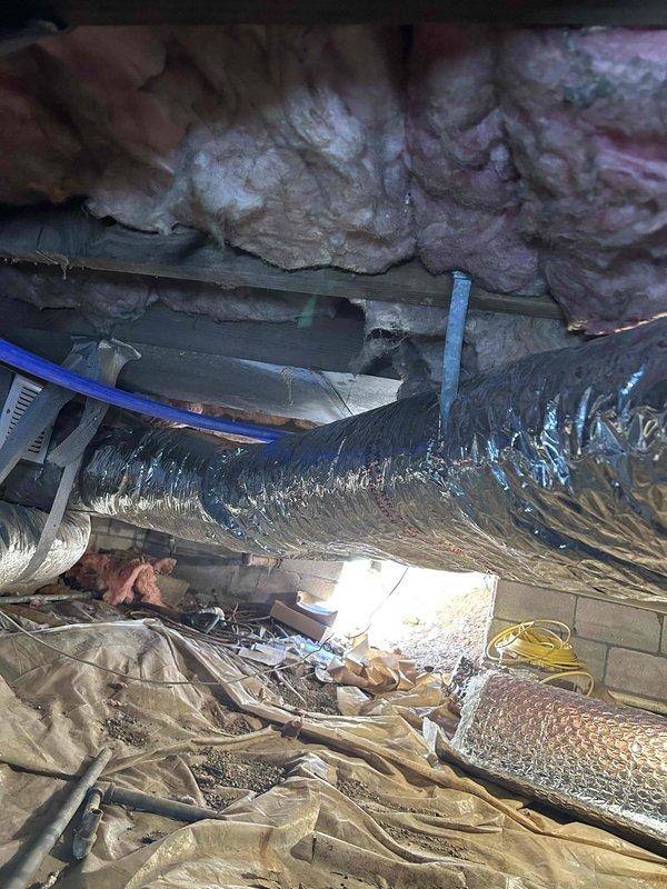 Repaired and secured HVAC ductwork in crawlspace by re-insulating exposed flexible duct runs and installing proper strapping to support sagging sections. Ensured all flex duct was properly supported per code requirements and insulation was restored to maintain system efficiency.