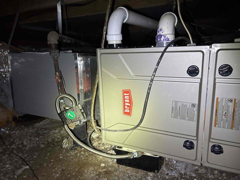 Responded to customer concern regarding black dust discharge from Bryant furnace system. Performed thorough inspection of heating unit, ductwork, and ventilation components in basement installation. Investigated potential causes including heat exchanger integrity, blower assembly condition, and air distribution system. Examined furnace cabinet, PVC venting configuration, and accessible ductwork including insulated flex duct runs in crawl space areas. Assessed filter housing and airflow pathways to identify source of particulate contamination. Provided customer with findings and recommendations for resolution of dust issue and safe system operation.