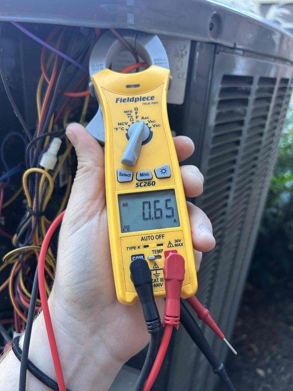 Completed Gold Level prepaid maintenance on single-system residential HVAC unit. Performed comprehensive inspection of outdoor condensing unit and indoor evaporator coil, verified electrical readings using clamp meter showing normal amperage draw of 0.65A, and inspected coil conditions. Documented equipment status with photos showing minor dust accumulation on evaporator fins and aging insulation sealant at coil housing junction; system operating within normal parameters with no immediate service needs identified.