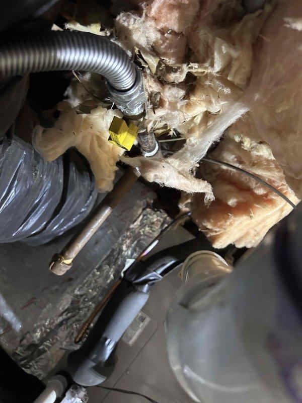 Completed callback to address post-installation items including documentation of furnace drip leg and shut-off switch installations per code requirements. Photographed gas line drip leg assembly and electrical disconnect switch in attic space showing proper code-compliant installation. Reconnected dryer vent ducting at crawlspace entrance that was inadvertently left disconnected during original equipment installation. Secured loose brick at exterior foundation back to original position to restore structural integrity at affected area.