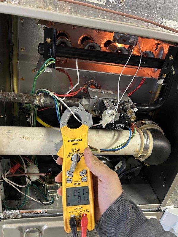 # HVAC Maintenance - Club Single

Completed Gold Level preventive maintenance service on single-system HVAC unit located in garage. Performed comprehensive system inspection and diagnostics using Fieldpiece SC440 digital multimeter to verify electrical performance and component operation. Tested voltage, amperage, and continuity across gas valve, control board connections, and burner assembly to ensure proper electrical function throughout the heating system.

Inspected internal components including gas valve, ignition system, burner assembly, and heat exchanger. Verified all wire connections (red, white, green, and blue) were secure and properly terminated. Examined mounting hardware and fasteners for integrity. Documented system readings and operational parameters using clamp meter functionality to measure current draw on electrical components.

System operating within normal specifications. Filter replacement (#413) will be provided during upcoming spring maintenance visit as part o