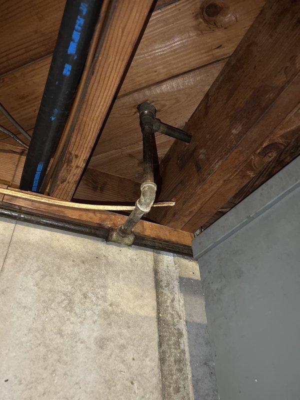 Responded to service call for gas leak detection and pressure testing with gas system operational. Performed comprehensive inspection of gas piping system in basement and attic areas, examining exposed gas lines, connections, and fittings for potential leaks. Conducted pressure test on gas line system to verify integrity and ensure no loss of pressure that would indicate active leaks. Inspected multiple pipe junctions, T-fittings, and connection points throughout the accessible areas, paying particular attention to aged connections showing discoloration. Verified all gas line components were properly secured and functioning safely with system remaining operational throughout testing process.