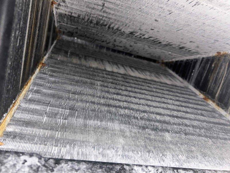 Completed scheduled care plan tune-up on heat pump and air handler system located in attic. Performed comprehensive inspection of heat exchanger coils, noting dust and debris accumulation on metallic fins with some discoloration present. Inspected pleated air filter in metal housing, which showed signs of use with dust particles and slight discoloration on filter media. System operational and maintenance service completed per recurring service agreement specifications.