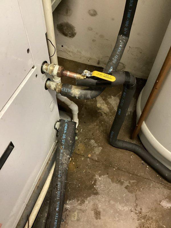 Performed a water leak locate on the domestic water supply line connected to the desuperheater and identified moisture and staining at the insulated copper piping and fittings near the mechanical equipment. Inspected the adjacent water softener and associated shutoff valves and piping, documenting the affected areas with photos for repair planning.