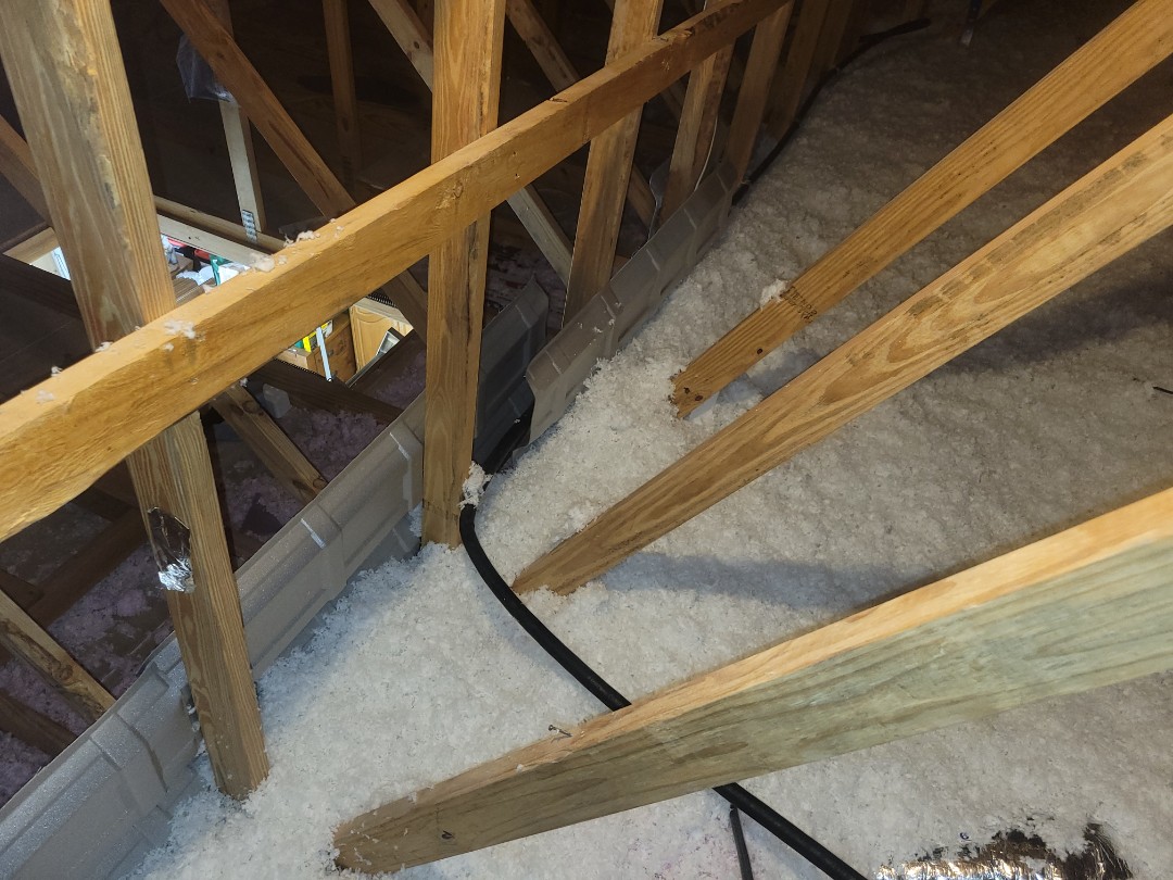 Installation of blown in fiberglass insulation to a value of R-38