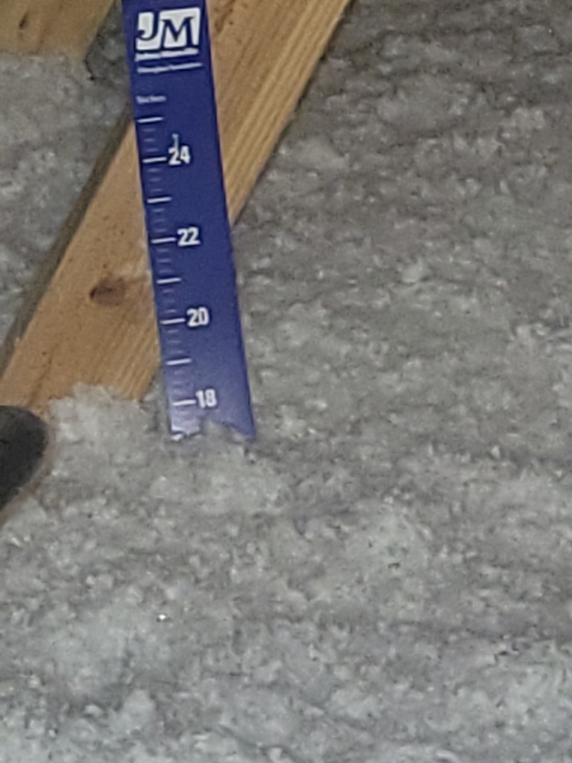 Installation of blown in fiberglass insulation to a value of R-38