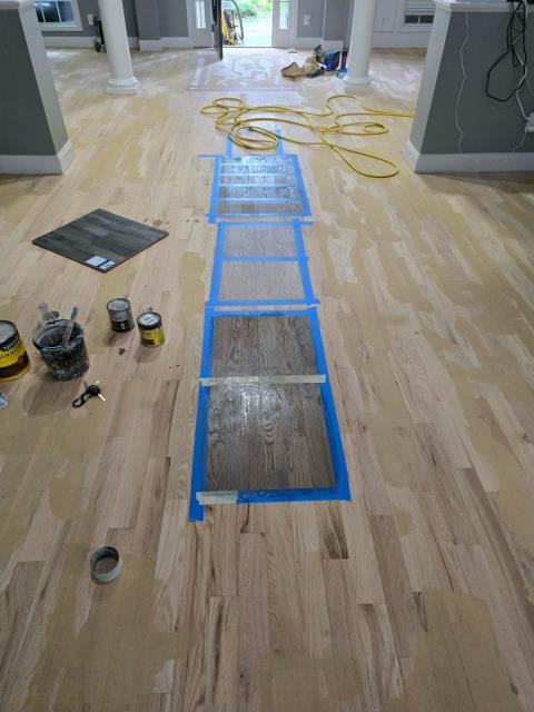 Refinishing solid hardwood floors in Winston, GA. Putting down stain samples for client. 