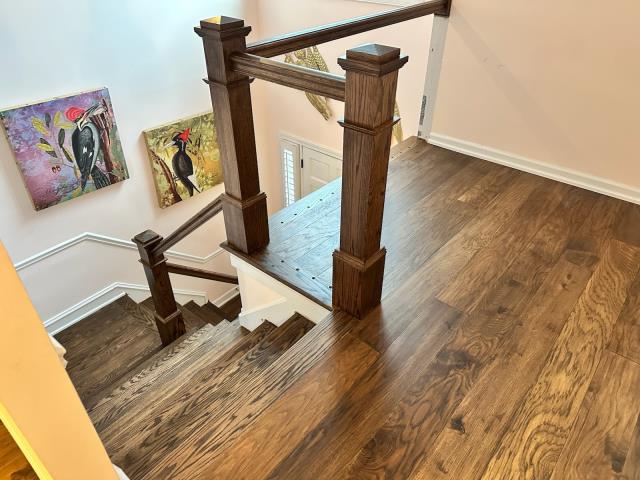 We installed new engineered hardwood and stained the new stair parts to match at this home in Roswell, GA.