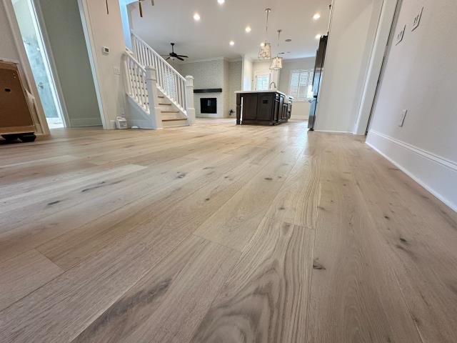 We removed glued down engineered hardwood from this home in Alpharetta, GA. We installed an updated wider plank, white oak engineered hardwood with a lighter/matte finish. 