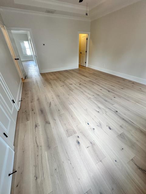 We removed glued down engineered hardwood from this home in Alpharetta, GA. We installed an updated wider plank, white oak engineered hardwood with a lighter/matte finish. 